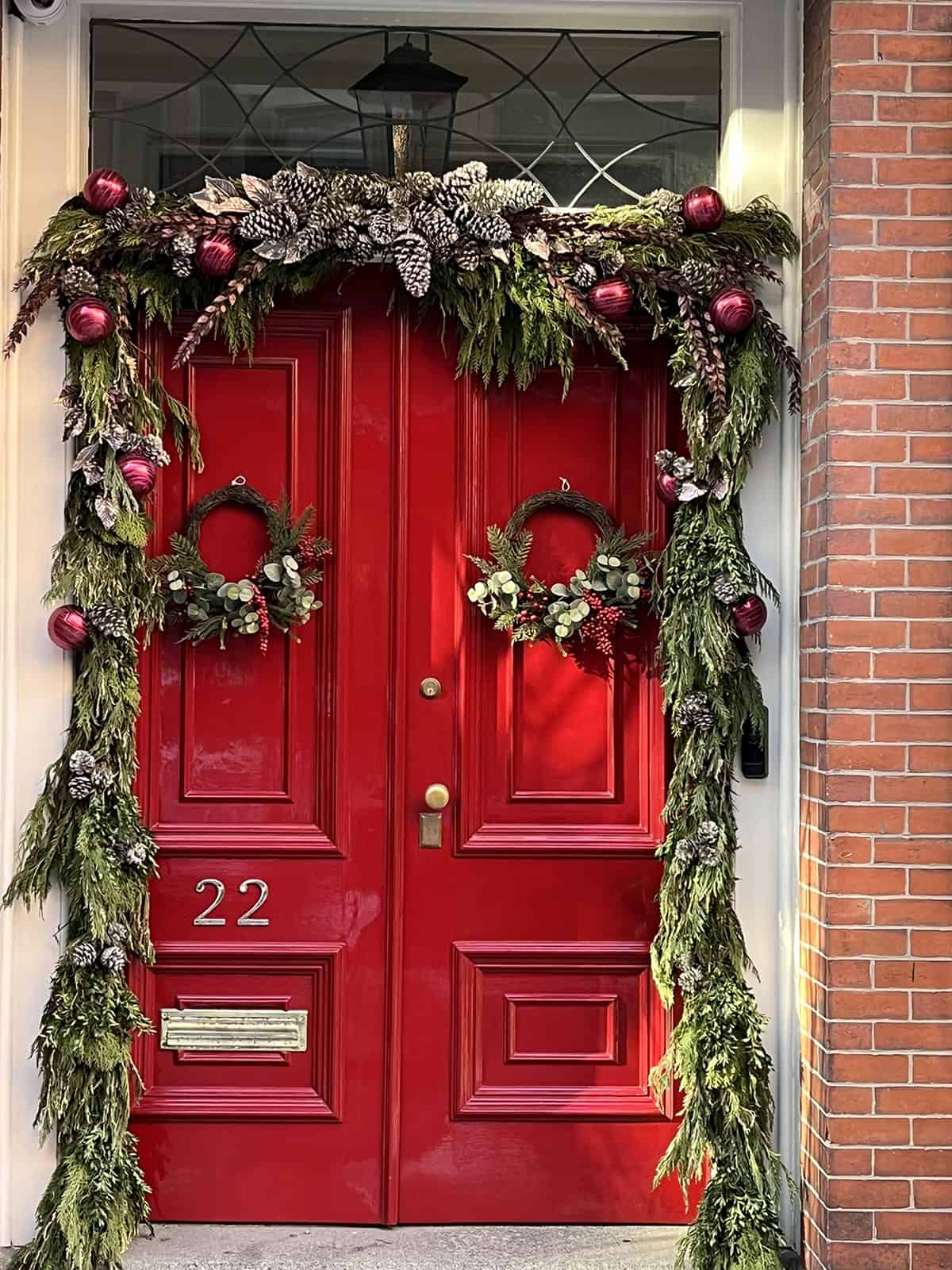 Red Door Framed with Pine and Burgundy Ornaments