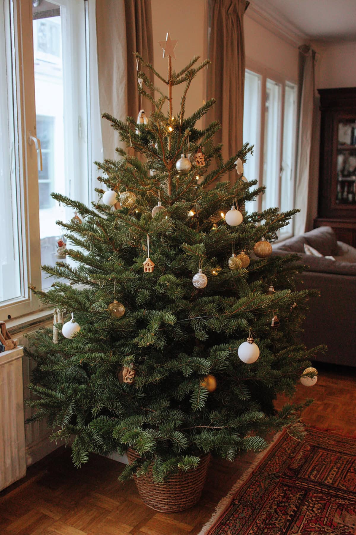 A Bare, Fresh Green Christmas Tree with Sparse Ornaments