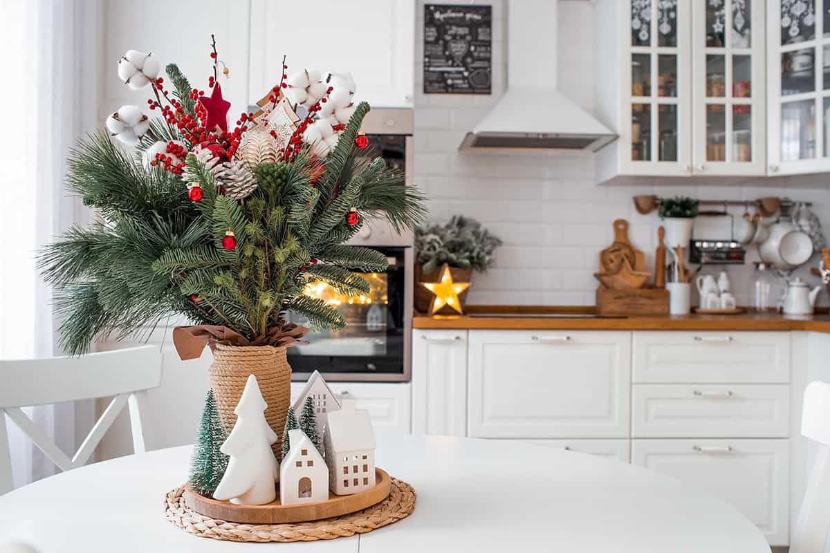 Evergreen Bouquet with Red Berries in a White Nordic Kitchen