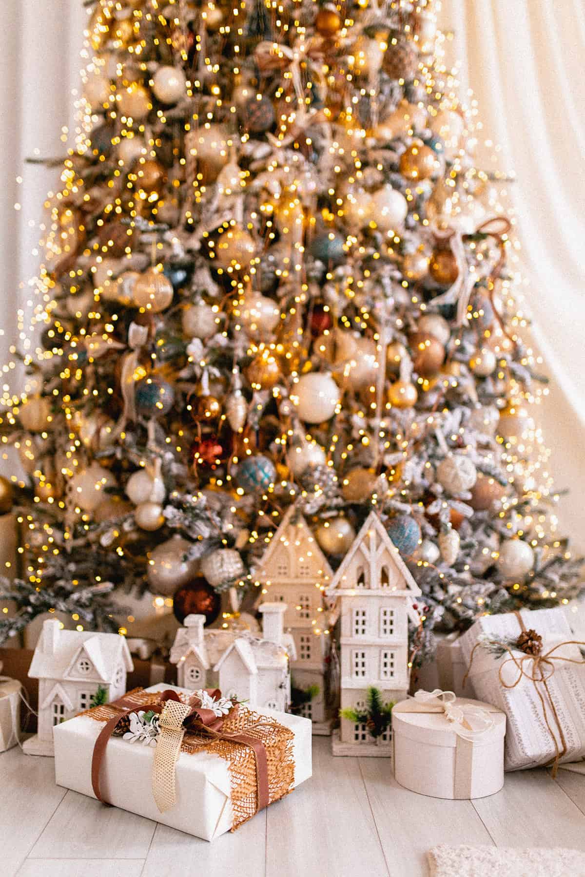 Frosted Tree with Dense Ornaments and White Village Houses
