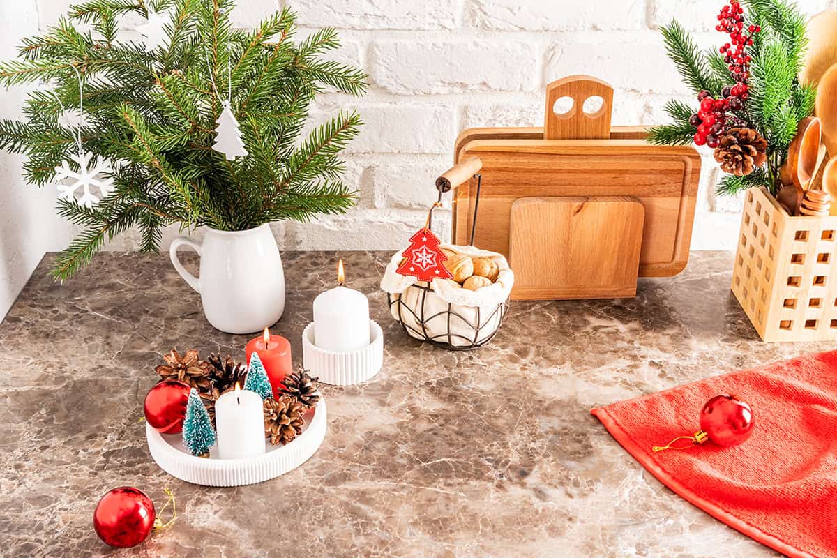 Tray with Candles and Evergreen Sprigs on a Kitchen Counter
