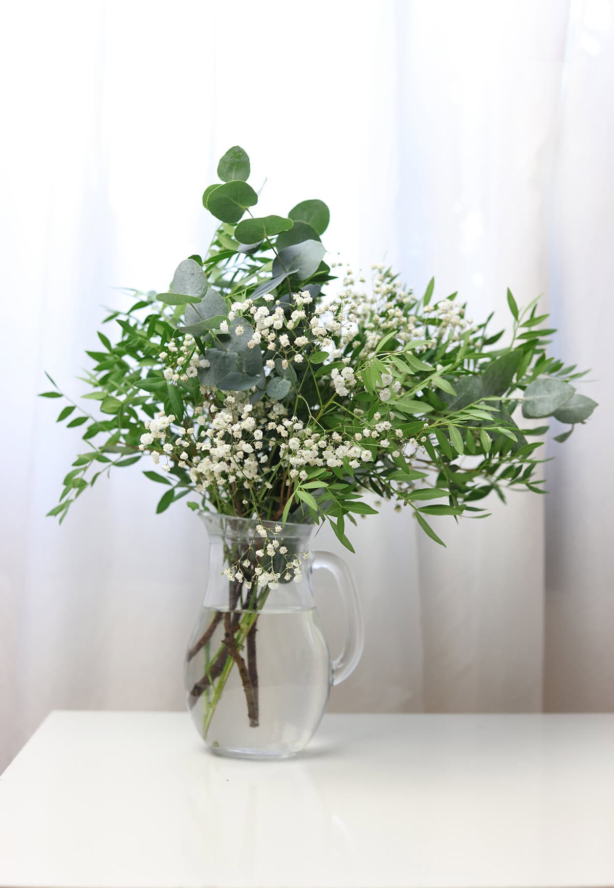 Eucalyptus and Baby’s Breath in a Clear Pitcher