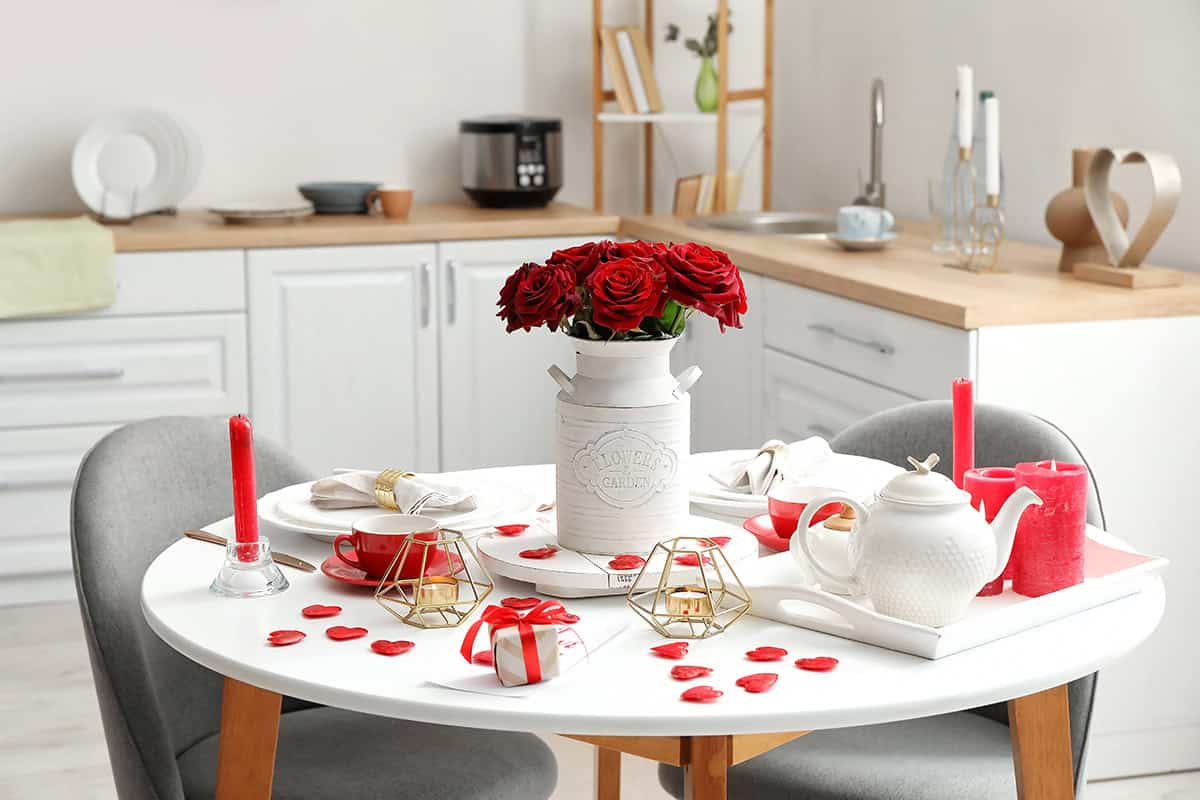 White Table with Red Candles and Metal Accents