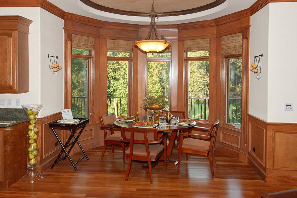 Bay Window Dining Nook With Warm Wood Paneling