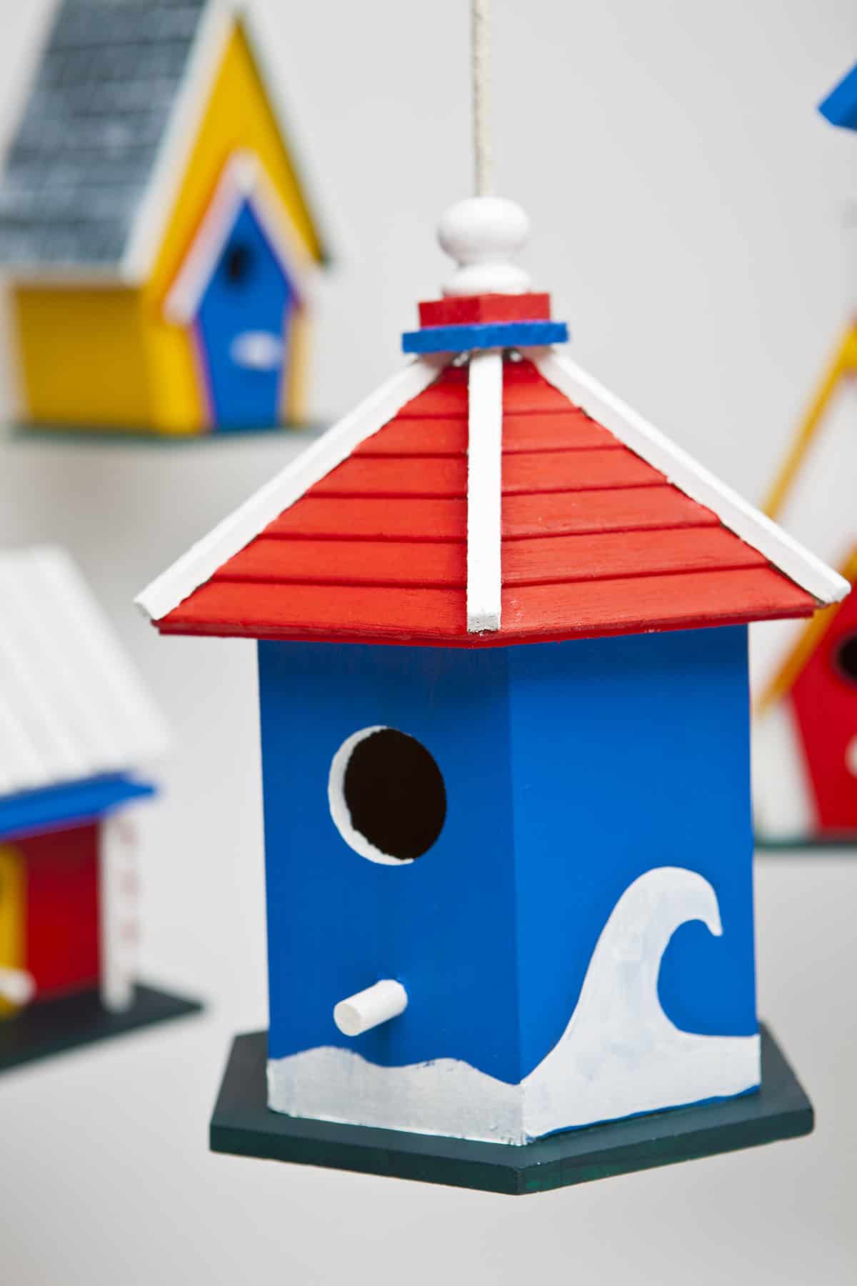 Blue Coastal Birdhouse With a Bright Red Roof