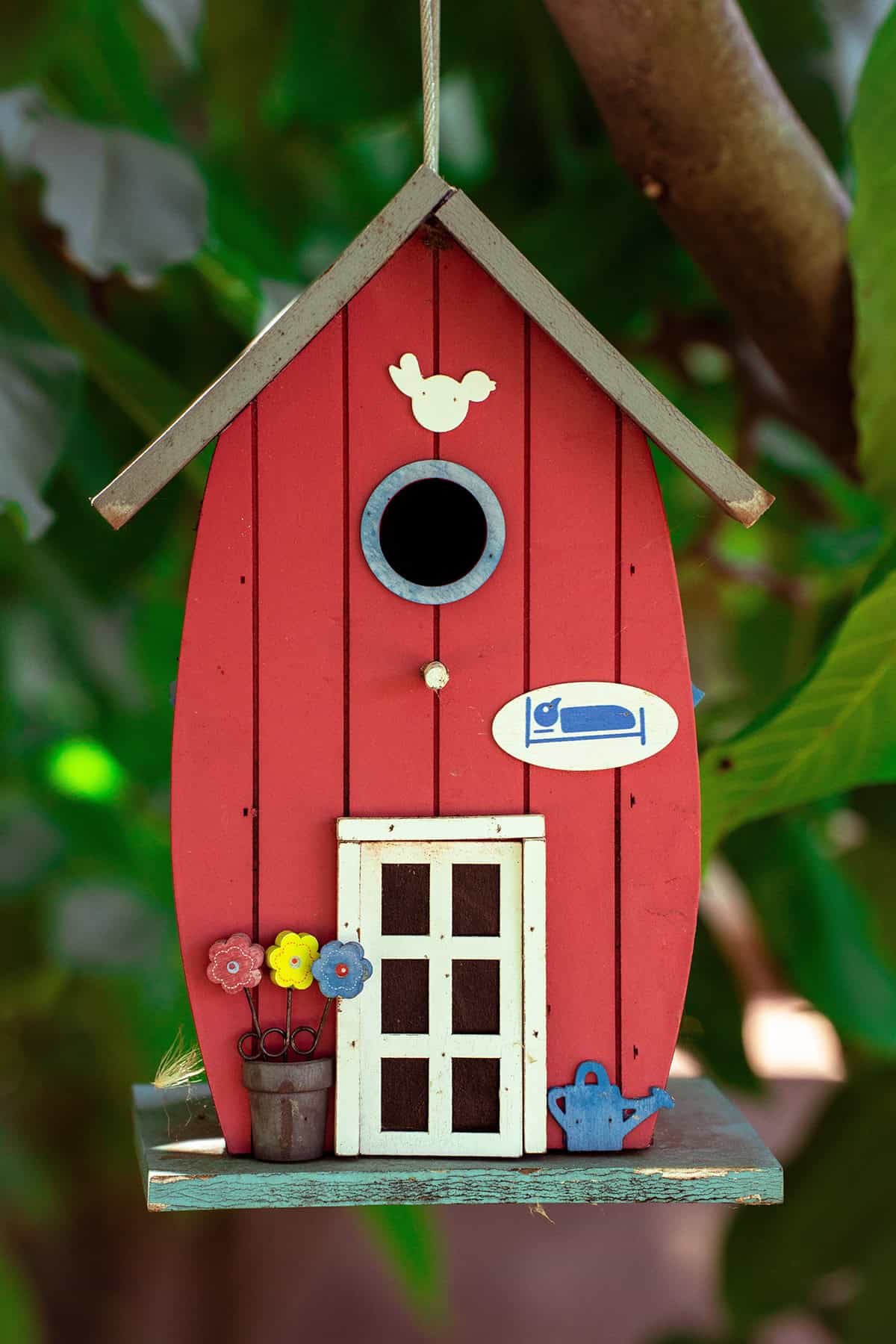 Bright Red Birdhouse With Flower Pot Detail