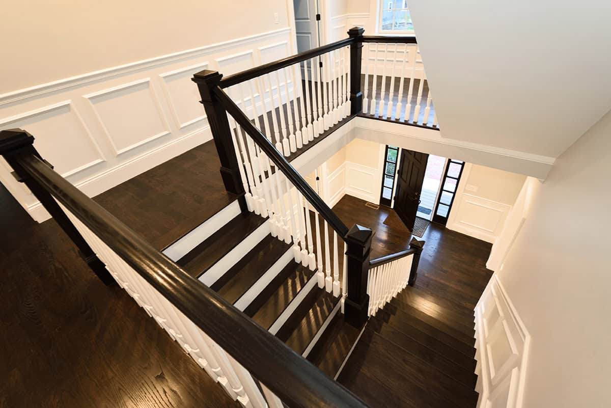 Classic White Stair Wainscoting with Black Floors For High Constrast