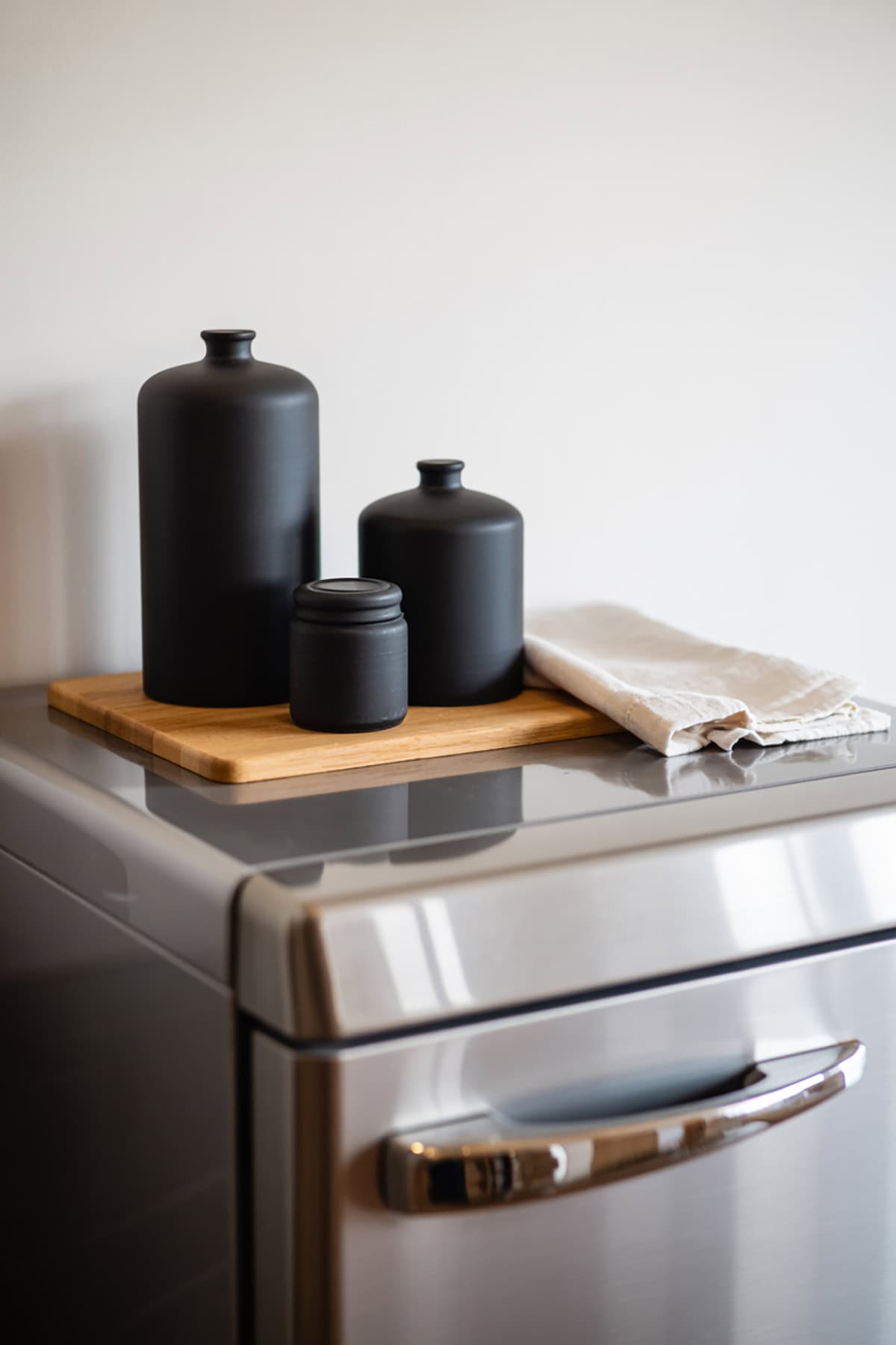 Matte Black Canisters On Oak Board