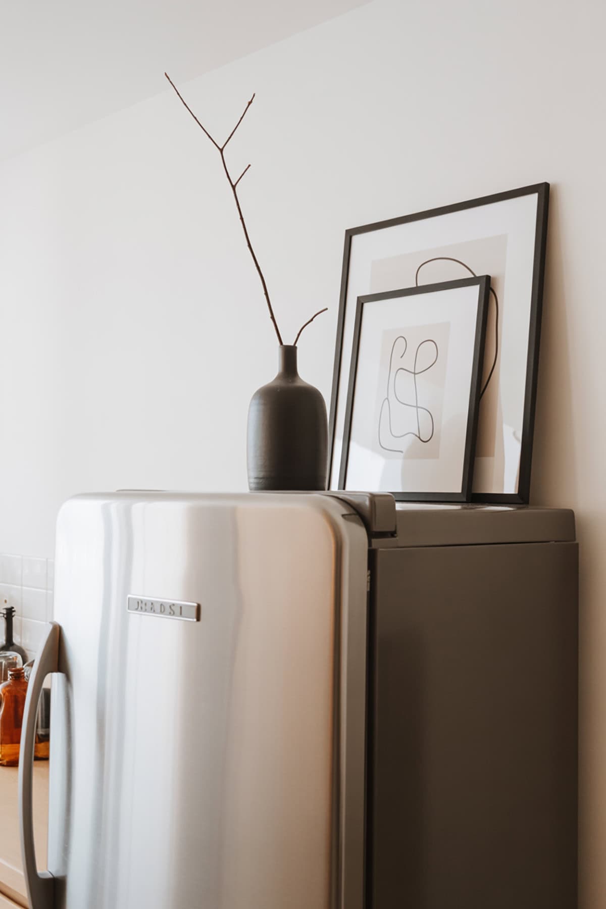 Two Leaning Frames + Matte Black Vase