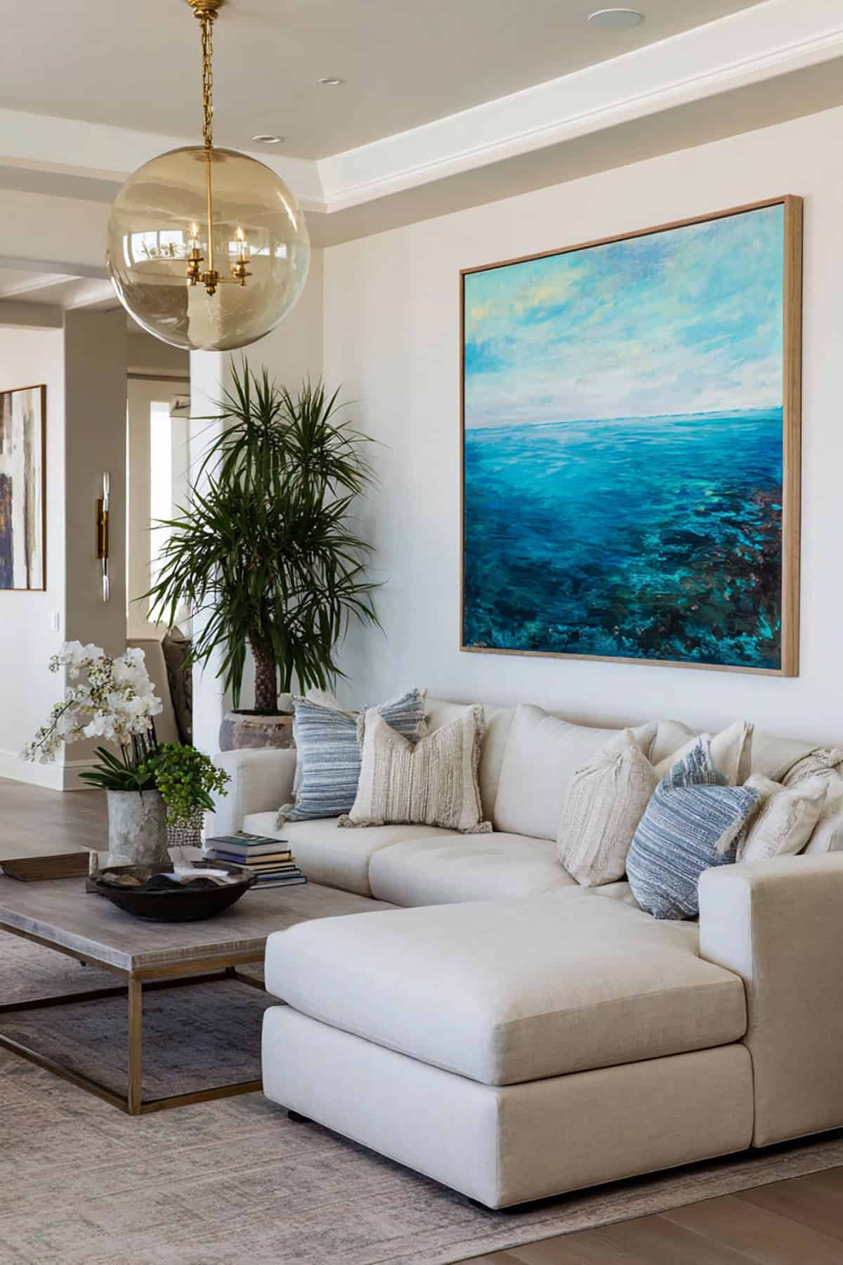 Oversized Ocean Artwork as Focal Point Above Neutral Seating