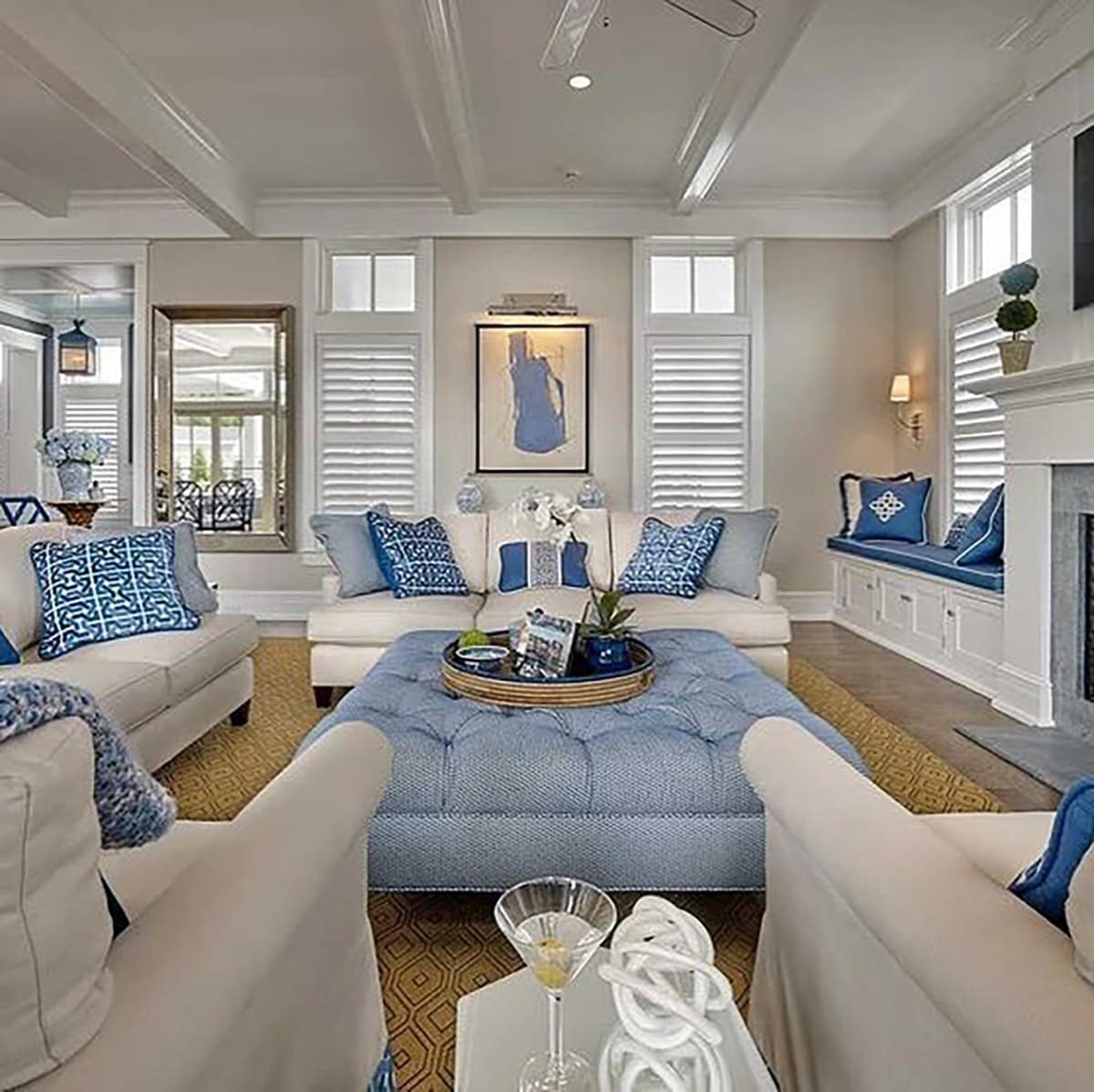 Symmetrical Layout with Blue Tufted Ottoman Table as Soft Centerpiece