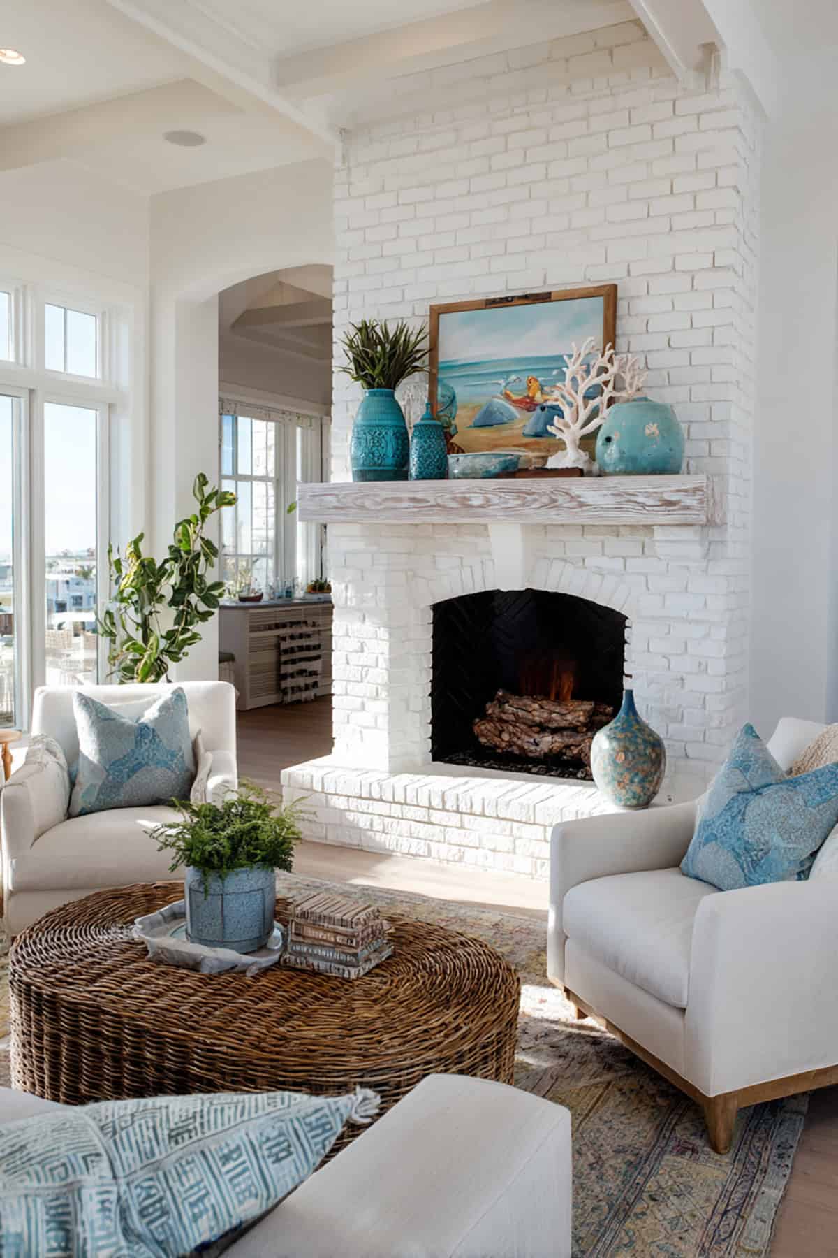 White Brick Fireplace with Driftwood Mantel and Coastal Decorative Accents