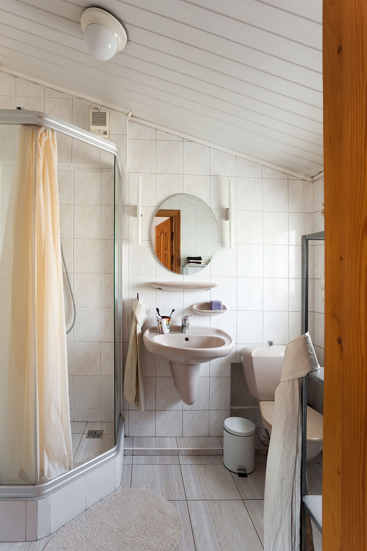 Sloped Ceiling Bathroom with Clean White Tiles