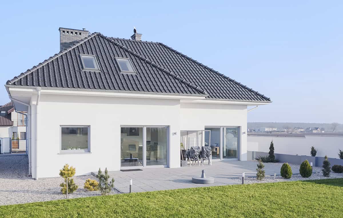 Simple White Bungalow Exterior With Gray Roofs and Modern Lines