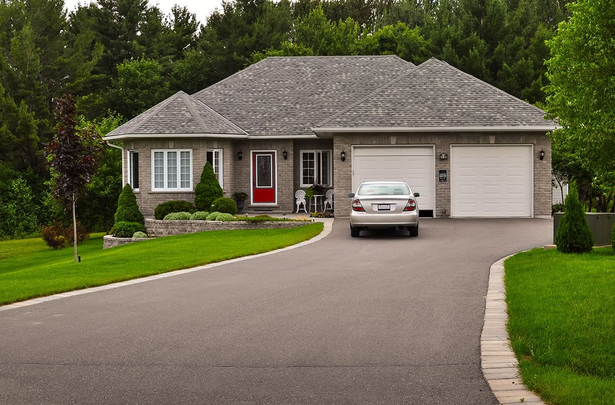 Suburban Bungalow Exterior With Wide Lawn Appeal and Curved Driveway