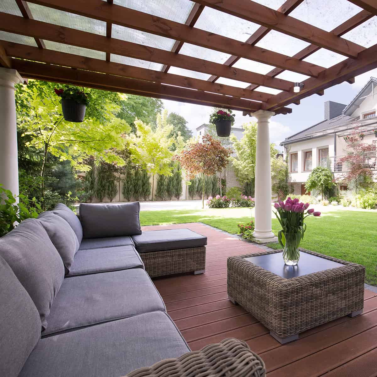 Wood Frame Covered Patio With Neutral Furniture And Brick Flooring