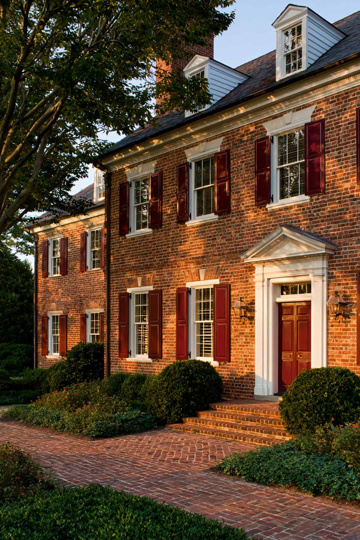 Burgundy Shutters On A Stately Brick Home