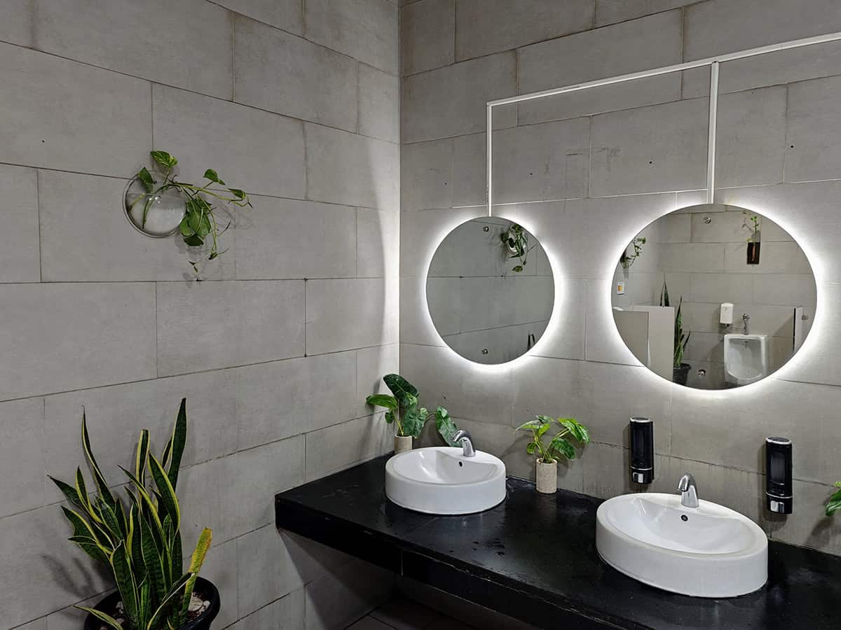 Concrete Double Vanity With Glowing Round Mirrors