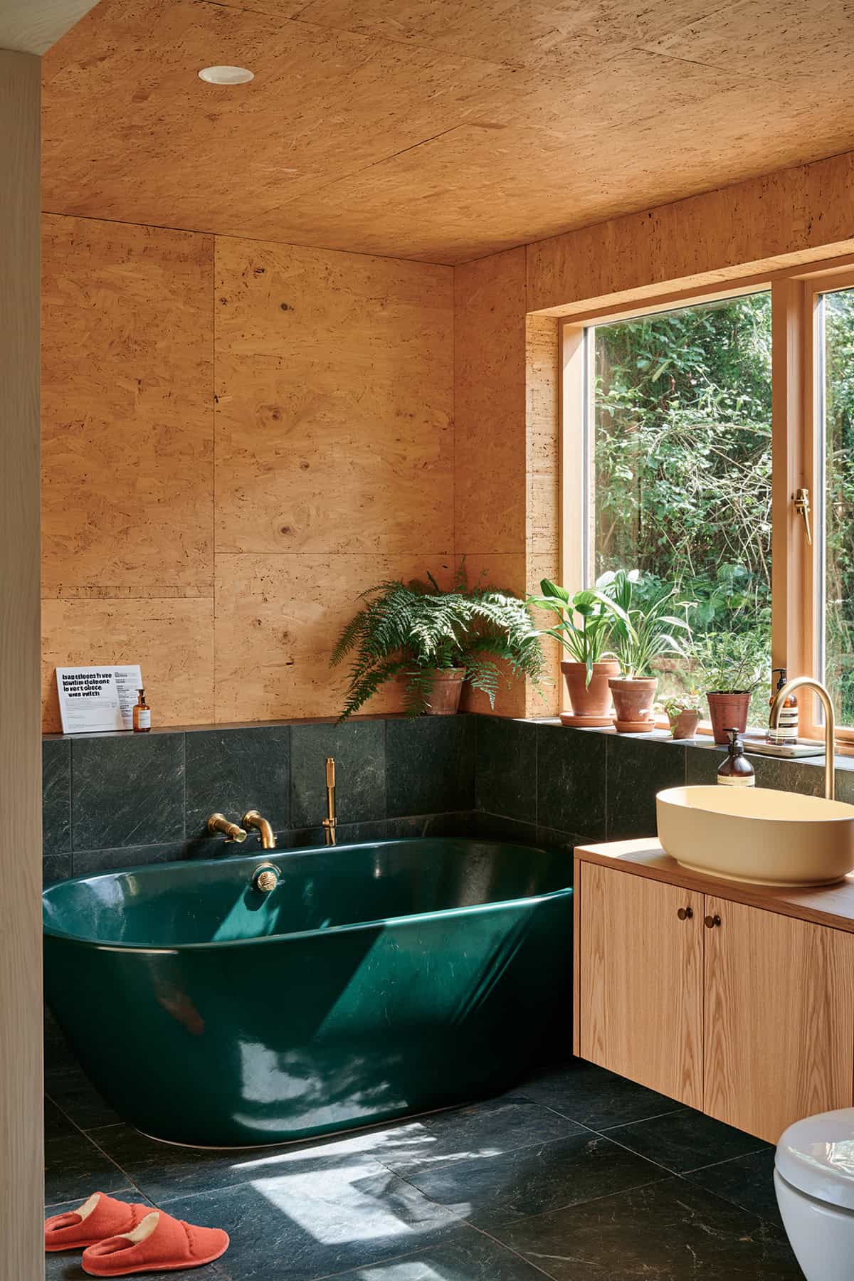 Cork Walled Bathroom With A Deep Green Tub