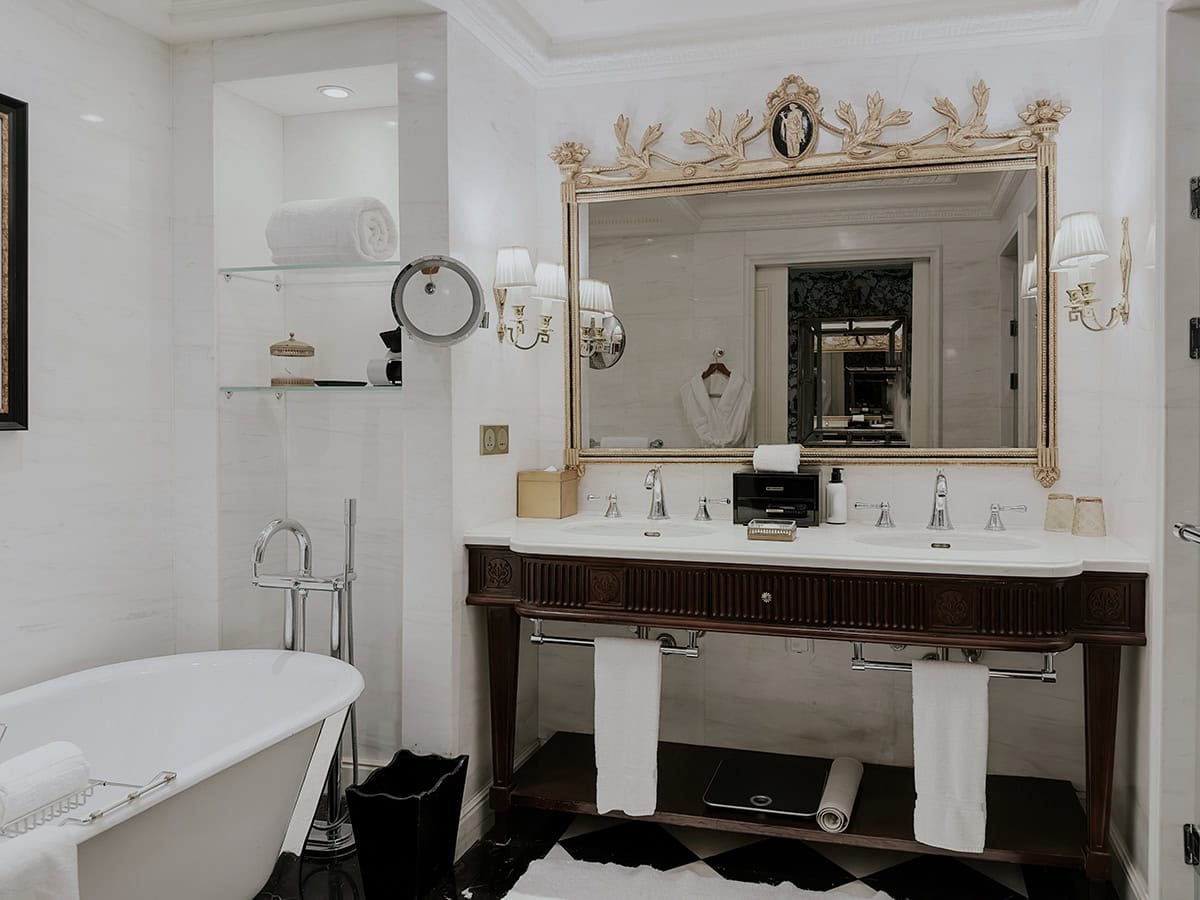 Dark Wood Vanity With An Ornate Mirror