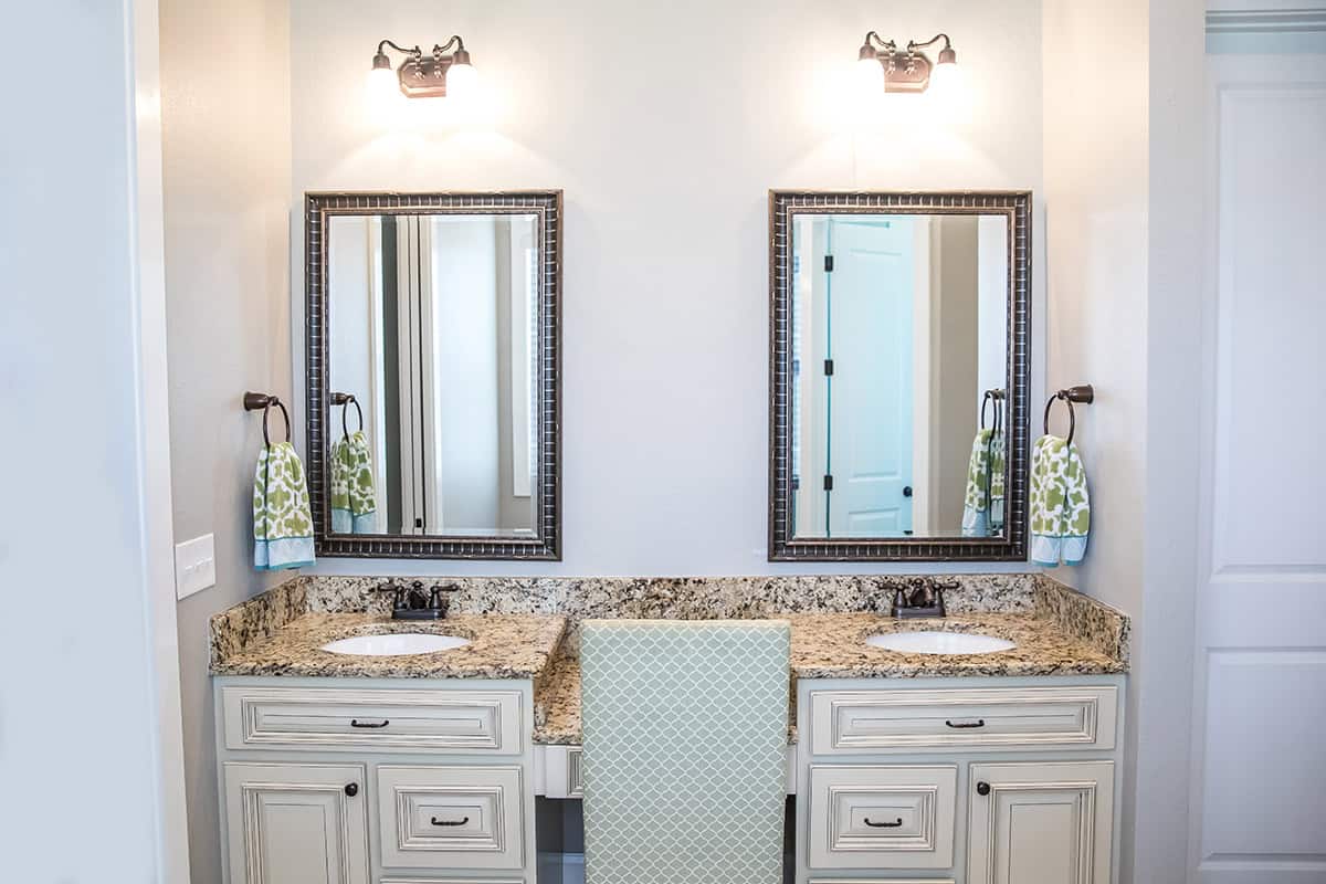 Double Vanity with Cream Cabinetry And Twin Mirrors