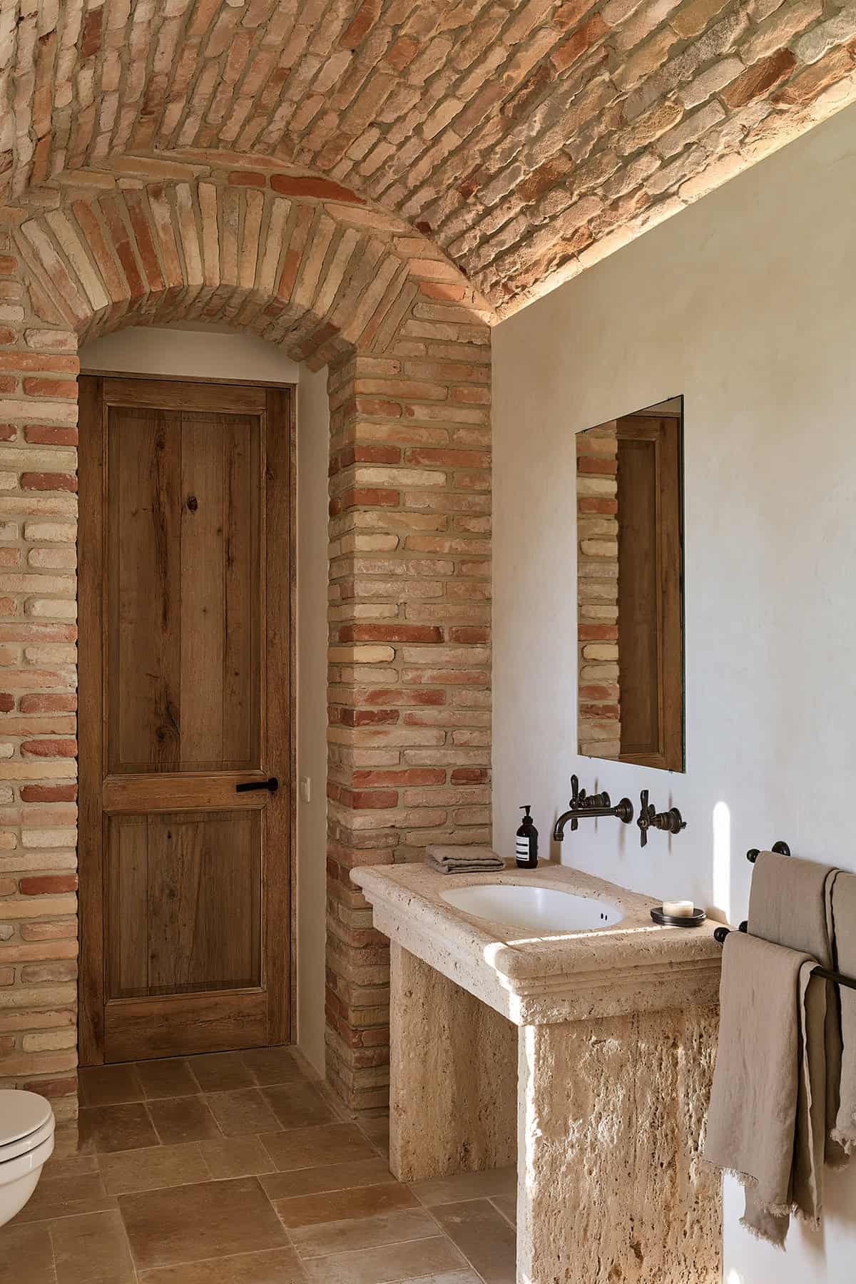 Earth Tone Bathroom With A Brick Barrel Ceiling