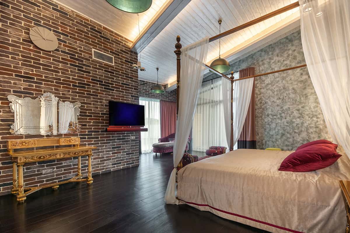Four Poster Bed In a Brick Walled Bedroom