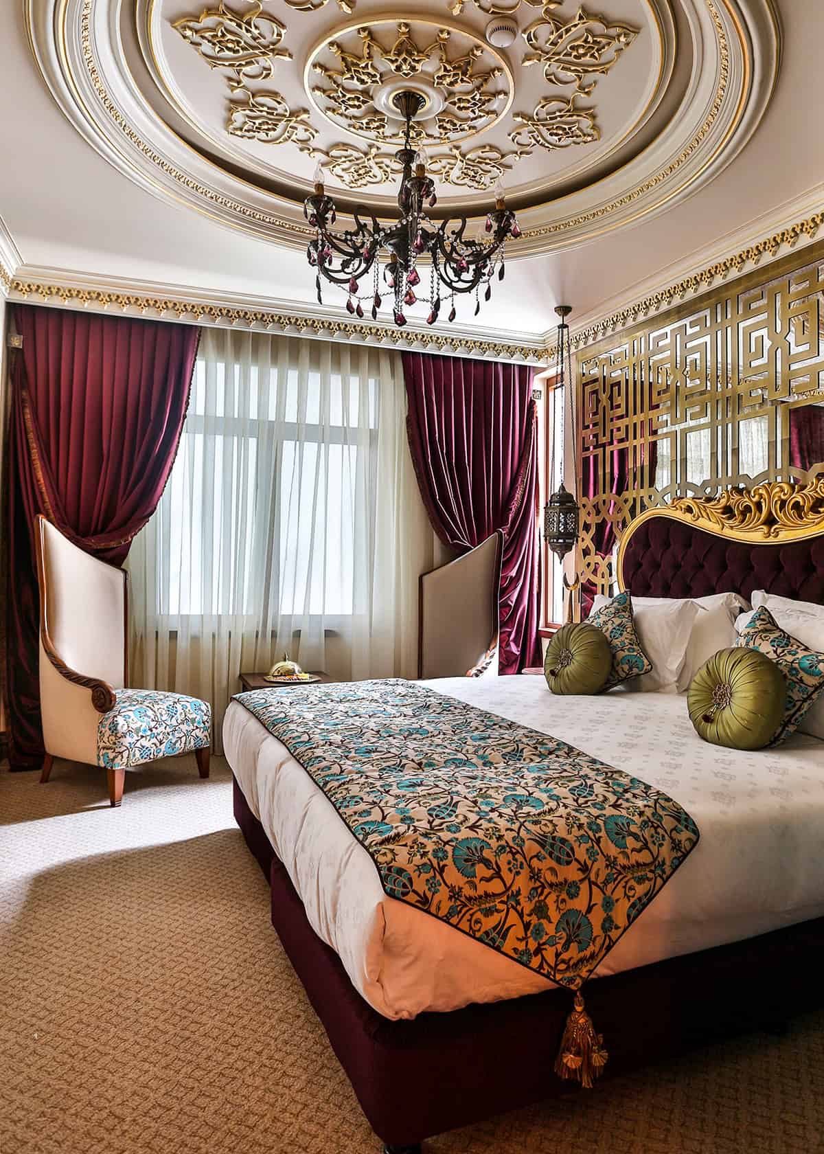 Jewel Toned Bedroom With an Ornate Ceiling