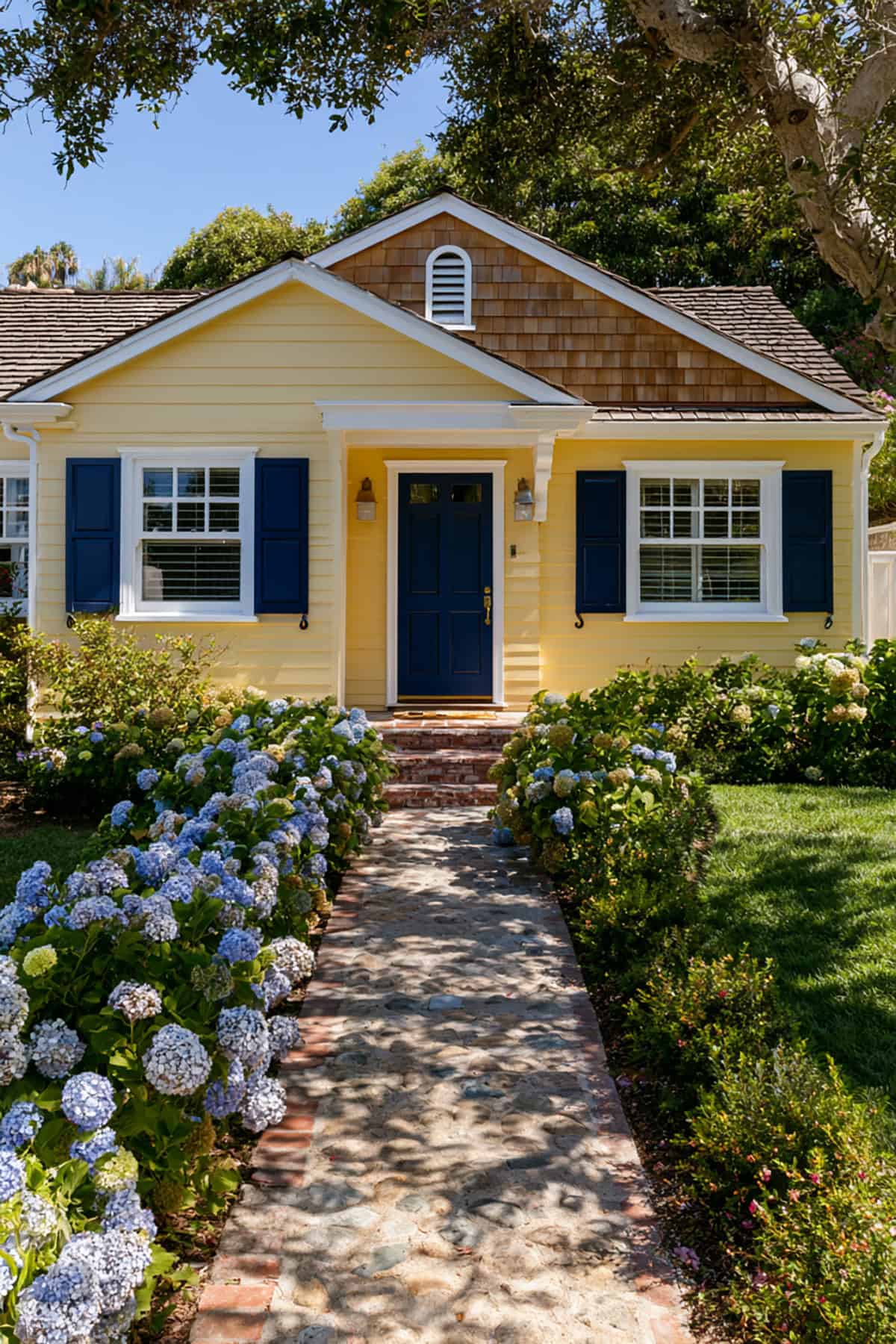 Navy Blue Shutters On A Yellow Coastal Cottage
