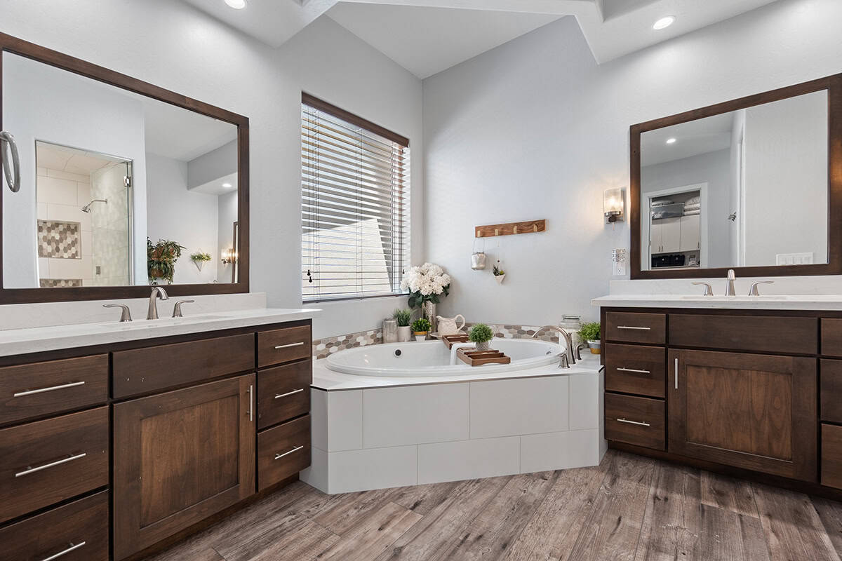 Separate Vanities Flanking A Corner Tub