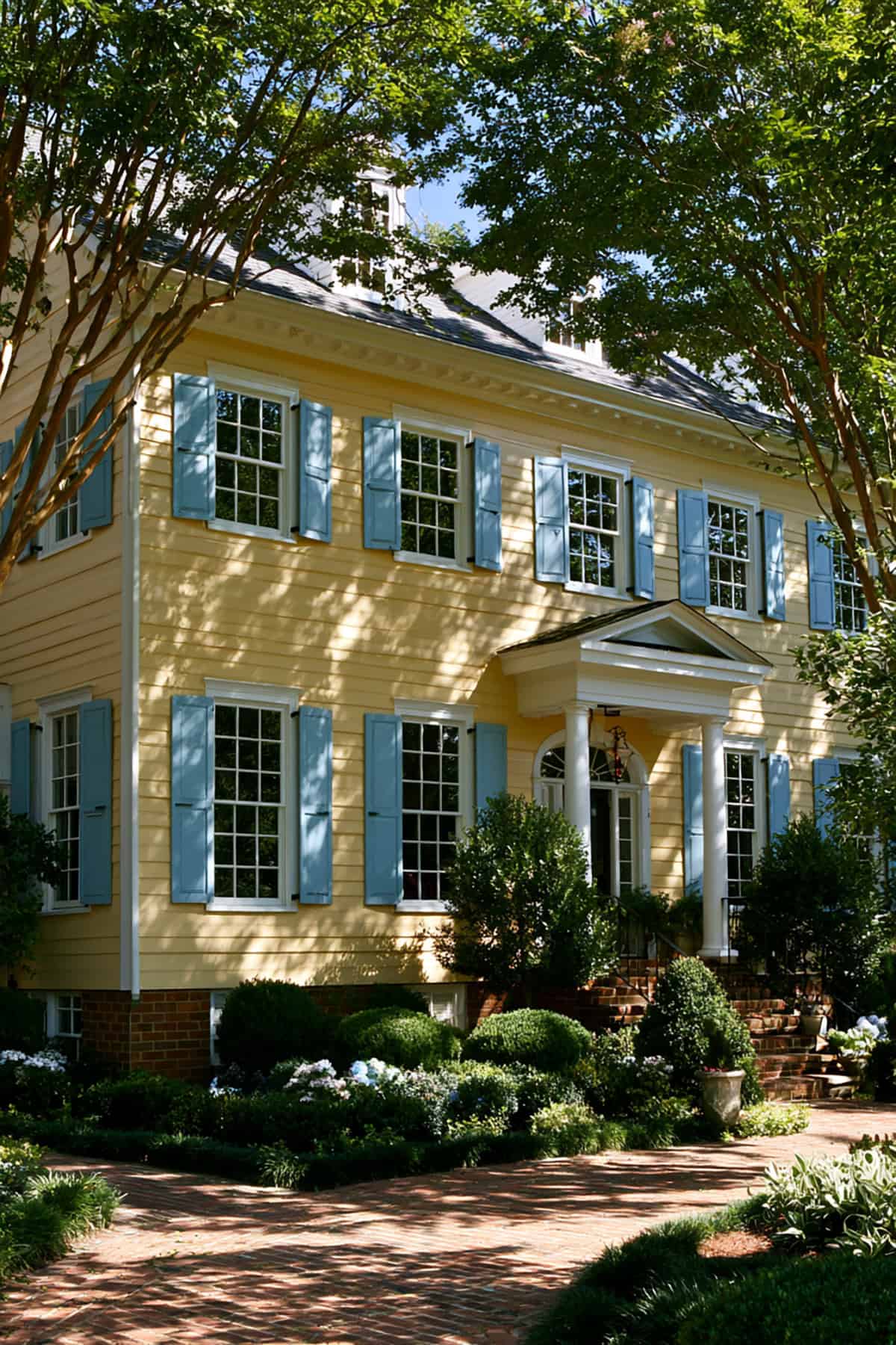 Slate Blue Shutters On A Yellow Traditional Home