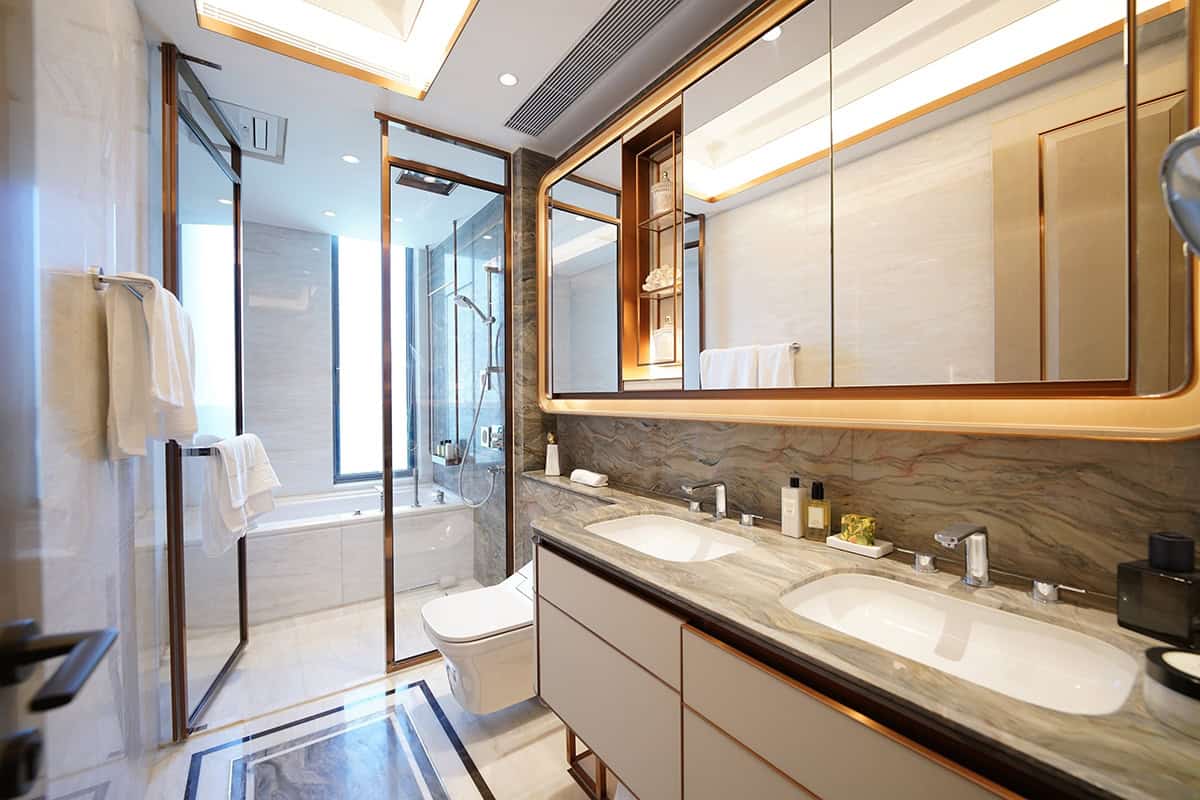 Sleek Double Vanity With A Full Wall Backlit Mirror