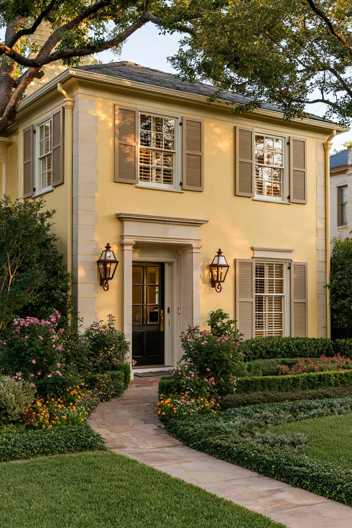 Taupe Shutters On A Yellow Traditional Home