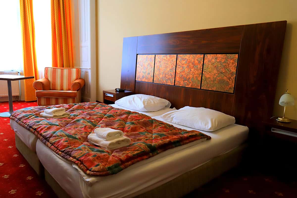 Warm Wood Headboard With Rust Bedding