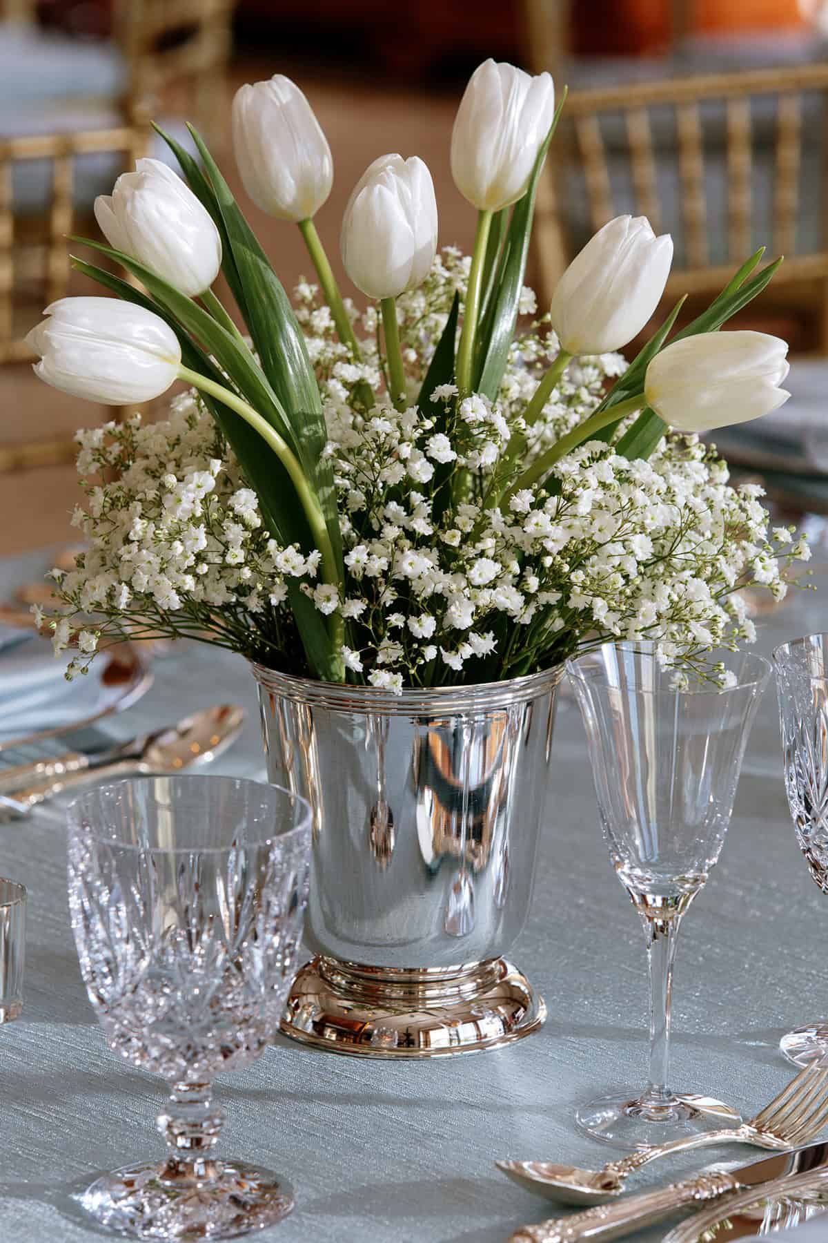 White Tulips And Baby’s Breath In A Champagne Bucket