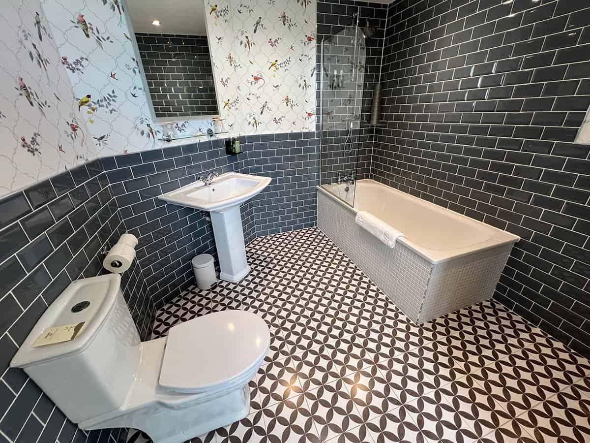 Bird Wallpaper Above Black Subway Tile
