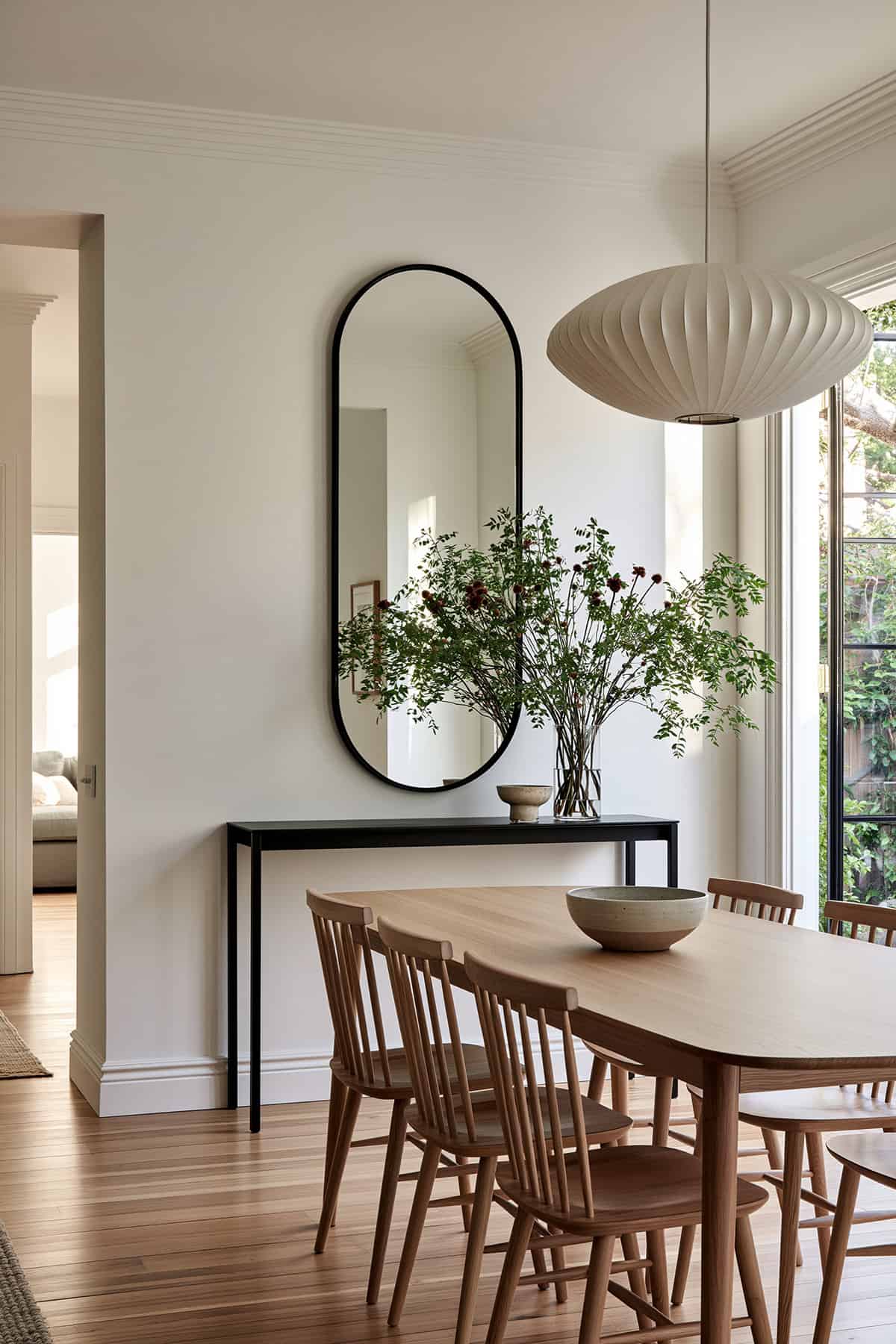 Black Oval Mirror in a Minimal Dining Room
