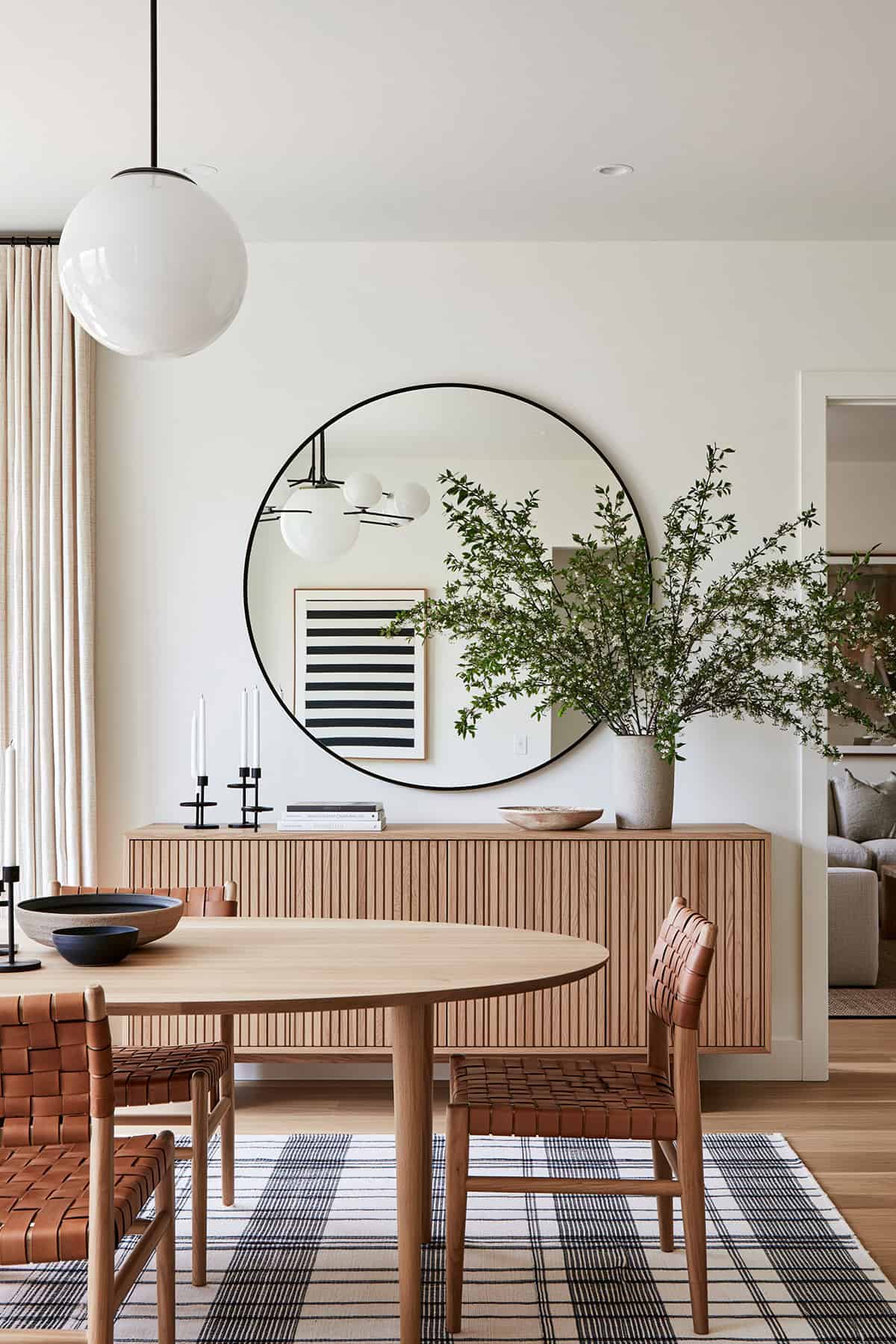 Round Mirror Above a Modern Buffet