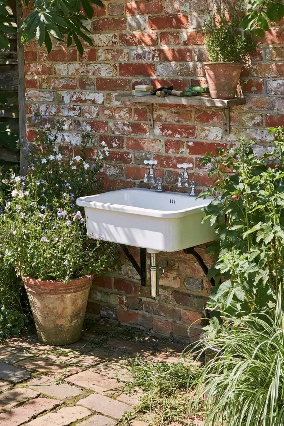 Vintage Cast Iron Sink Against A Garden Wall