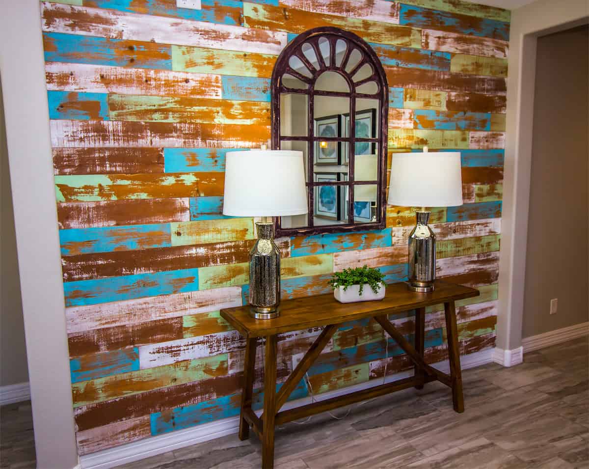 A Colorful Wall Behind an Arched Entryway Mirror