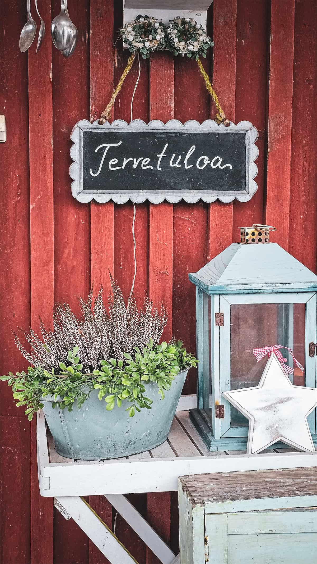 Porch Greenery Beside a Christmas Lantern